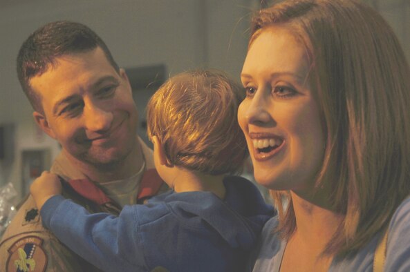 Lt. Col. Eugene Becker, 20th Special Operations Squadron commander, is greeted by his wife, Michelle, and 20-month-old son, Vincent at a homecoming ceremony Oct. 3, following the squadron's final deployment. The final mission for the 20th SOS, which flies the MH-53 Pave Low helicopter, took place Sept. 26 in Iraq. The aircraft will be retired and the squadron will be deactivated Oct. 17. (U.S. Air Force photo/ 1st Lt. Lauren Johnson)