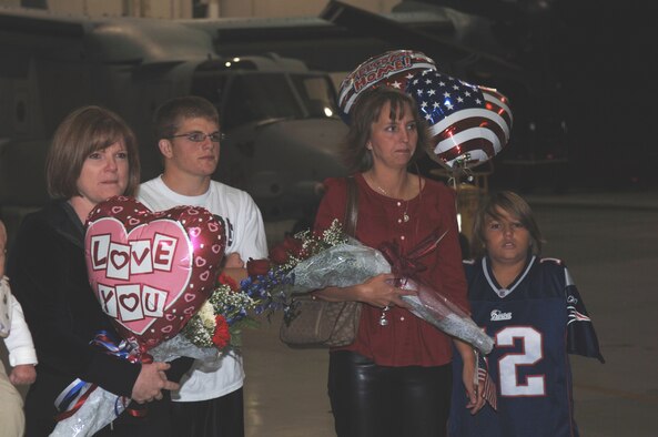Families anxiously await the homecoming of Tech. Sgt. Vincent Depersio, 20th Special Operations Squadron flight engineer, and Master Sgt. Bob Strong, 20th SOS aerial gunner following the squadron's final deployment at a ceremony here Oct. 3. The final mission for the 20th SOS, which flies the MH-53 Pave Low helicopter, took place Sept. 26 in Iraq. The aircraft will be retired and the squadron will be deactivated Oct. 17. (U.S. Air Force photo/ Captain Nathan Davidson)