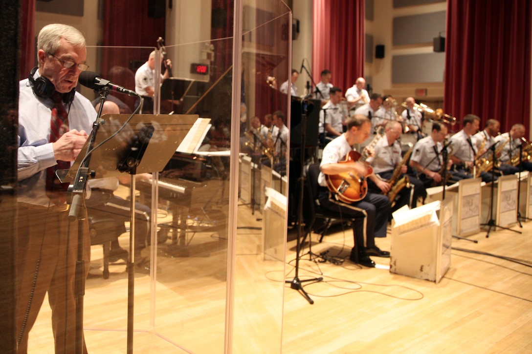 Special guest emcee Dick Golden prepares to read the script for a recording session with the USAF Band's Airmen of Note an trumpter Allen Vizzutti on October 2, 2008.  The session took place in Gabriel Hall of Historic Hanger 2 on Bolling Air Force Base in Washington, DC. The recording will be sent to radio stations across the United States and Canada for broadcast in 2009. (Official Air Force photo by Senior Master Sgt. Robert Mesite)