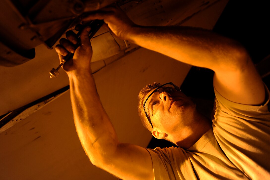 Staff Sgt. Danny Shaw installs safety wiring around a bolt on an F-16 Fighting Falcon Oct. 6 during some late-night maintenance at Joint Base Balad, Iraq. Installing safety wire prevents parts of the aircraft from vibrating off. Sergeant Shaw, an aerospace propulsion journeyman with the 332nd Expeditionary Aircraft Maintenance Squadron, is deployed from Misawa Air Base, Japan. His hometown is Glasgow, Ky. (U.S. Air Force photo/Airman 1st Class Jason Epley)