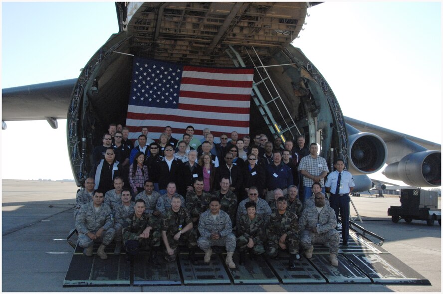 TRAVIS AIR FORCE BASE, Calif. -- 349th Maintenance Group hosted an Employer Appreciation Day for civilian employers of several of its Reserve members, Sep. 20. Here they stand with those employees on the nose ramp of a C-5 Galaxy cargo aircraft to pose for a group photo. The day began with a briefing by the 349th Air Mobility Wing commander, Col. Maryanne Miller; 349th Maintenance Group Commander Col. William Anholt  and Command Chief Master Sgt. Christine Taylor.  After the briefing they got on busses to the aircraft flight-line to board either a KC-10 Extender, refueling aircraft or a C-17 Globemaster III, cargo aircraft, where they got the opportunity to experience the Air Force mission and what their employees do—from the air. (U.S. Air Force photo by Master Sgt. Wendy Weidenhamer)