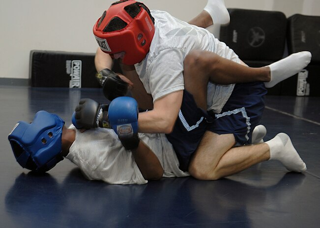 Staff Sgts. Brien Oxford, blue, and Jeremy Graves, red, practice Krav Maga techniques on Charleston AFB Oct. 8. Security Forces Ravens fly with  aircraft to maintain security when the aircraft are going to be landing in areas where the security level is unknown or additional security is needed. Sergeants Oxford and Graves are Ravens with the 437th Security Forces Squadron. (U.S. Air Force photo/Airman 1st Class Katie Gieratz)
