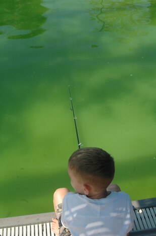 Justin Cole fishes for striped bass at the Charleston AFB Fishing Derby Oct. 4 at the base pool. The Charleston AFB Fishing Derby was an opportunity for base members to fish for fun. Justin is the son of Chief Master Sgt. Robert Cole, 1st Combat Camera Squadron. (U.S. Air Force photo/Staff Sgt. Sam Hymas)