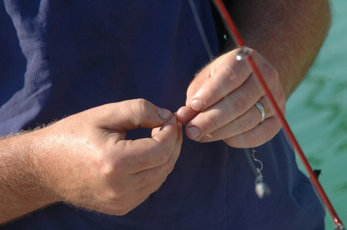 Andy Burrow ties a hook on his line at the Charleston AFB Fishing Derby Oct. 4 at the base pool. Charleston AFB closed the pool in style by filling it with striped bass and inviting Team Charleston members to catch them. Mr. Burrow is the Wrenwoods Golf Course superintendent. (U.S. Air Force photo/Staff Sgt. Sam Hymas)