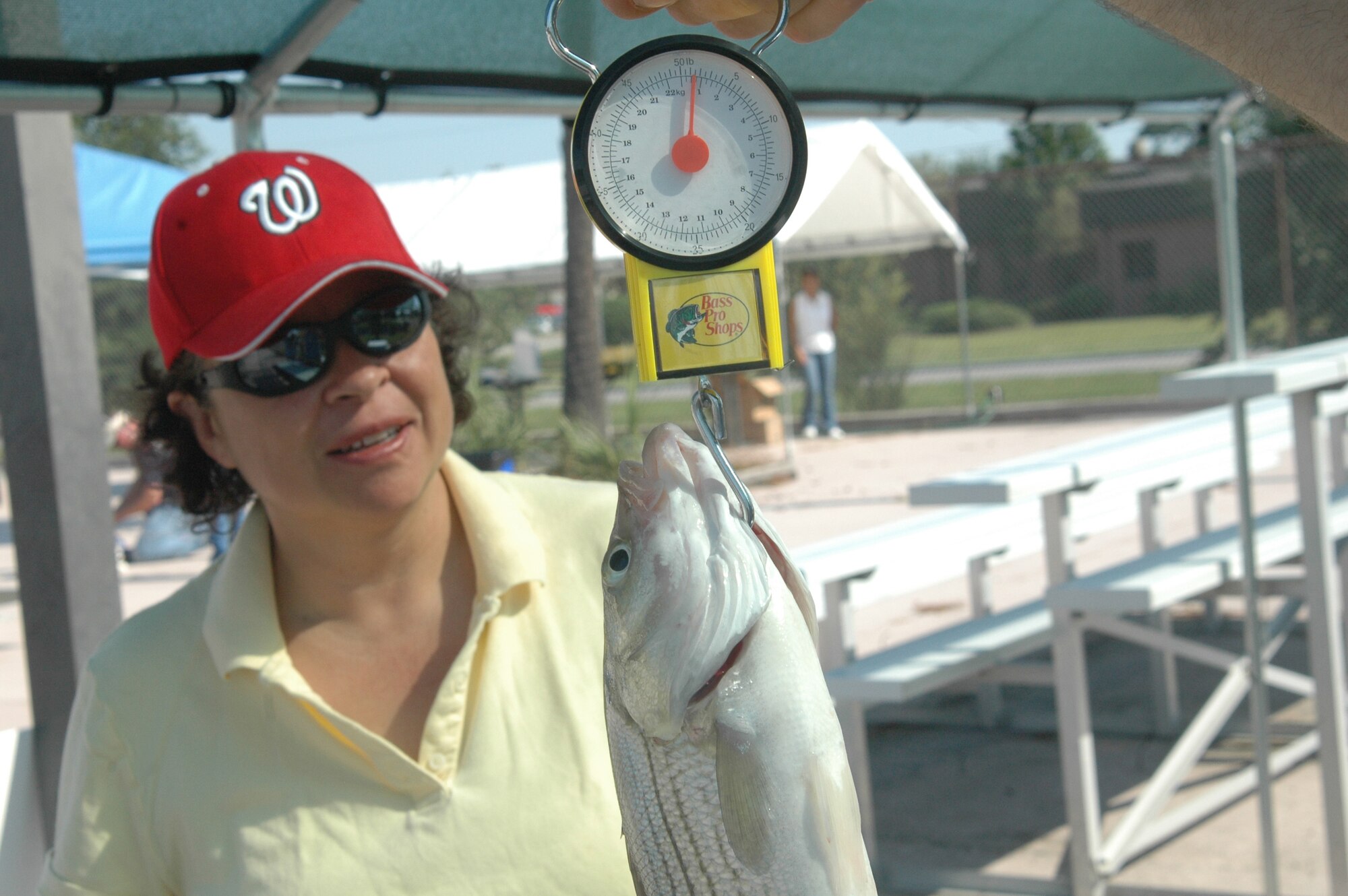 Rose Guevara watches the scale for the weight of her fish at the Charleston AFB Fishing Derby at the base pool Oct. 4. Charleston AFB closed the pool in style by filling it with striped bass and inviting Team Charleston members to catch them. Ms. Guevara is an Arts and Crafts Center employee. (U.S. Air Force photo/Staff Sgt. Sam Hymas)