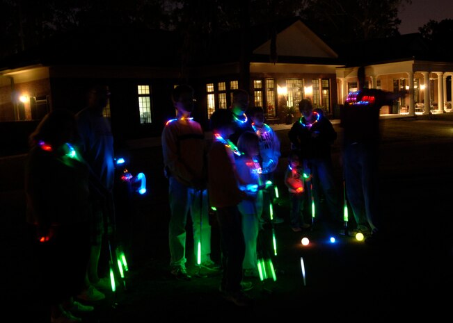 Team Charleston members participate in a night time putting challenge with glow sticks indicating where to put on the green at the 437th Force Support Squadron Camp Little Links at the Wrenwoods Golf Course on Charleston AFB Oct. 3. More than 15 Team Charleston participated in the Little Links Camping event. (U.S. Air Force photo/Airman 1st Class Timothy Taylor) 
