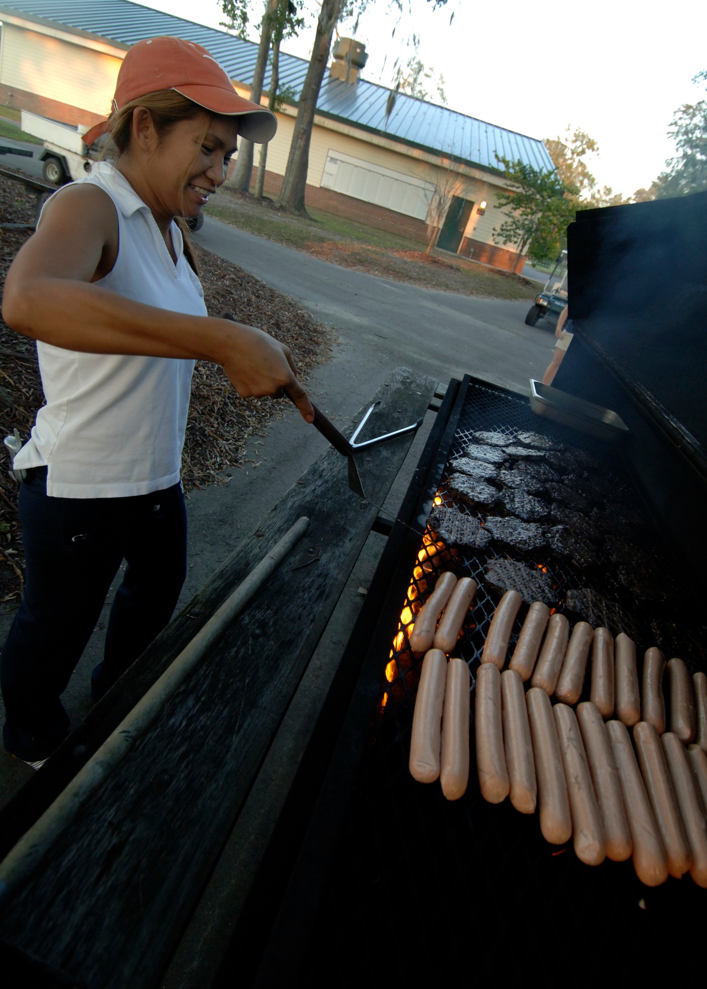Alma Whittemore grills hamburgers and hotdogs to feed the families participating in the 437th Force Support Squadron Camp Little Links at the Wrenwoods Golf Course on Charleston AFB Oct. 3. More than 15 Team Charleston members participated in the Little Links Camping event. Mrs. Whittemore is with the Force Support Squadron. (U.S. Air Force photo/Airman 1st Class Timothy Taylor) 
 
