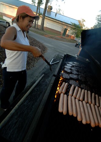 Alma Whittemore grills hamburgers and hotdogs to feed the families participating in the 437th Force Support Squadron Camp Little Links at the Wrenwoods Golf Course on Charleston AFB Oct. 3. More than 15 Team Charleston members participated in the Little Links Camping event. Mrs. Whittemore is with the Force Support Squadron. (U.S. Air Force photo/Airman 1st Class Timothy Taylor)  