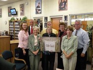 37th Services Division Chief Jerry Stanfill, right, and staff at the Lackland Library accept a $1500 gift card from the Friends of the Lackland Library and Officer's Wives Club and Security Service Federal Credit Union Sept. 29. The donation will help purchase materials such as bestsellers, DVDs and graphic novels for library customers. (USAF photo)
                            