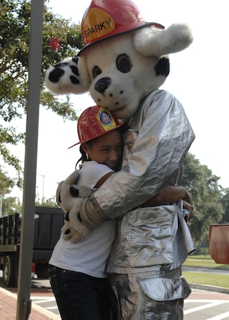 Destiny Graham hugs Sparky at Youth Programs on Charleston AFB Oct. 7. Firefighers came out to perform a fire drill, show the children the firetruck and let them meet Sparky during Fire Prevention Week. Destiny is the daughter of Quasheshe Hays from the 315th Mission Support Group. (U.S. Air Force photo/Airman 1st Class Katie Gieratz)
