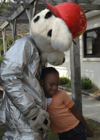 Destiny Brown hugs Sparky at Youth Programs on Charleston AFB Oct. 7. Firefighers came out to perform a fire drill and show the children the fire truck and let them meet Sparky during Fire Prevention Week. Destiny is the daughter of Staff Sergeant Angelique Devor from the 437th Logistics Readiness Squadron and Senior Airman Brett Devor from the 437th Communications Squadron. (U.S. Air Force photo/Airman 1st Class Katie Gieratz)