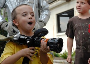 Austin Abel learns how to operate the water hose from a fire truck at Youth Programs on Charleston AFB Oct 7. Firefighers came to Youth Programs to teach children about fire safety during Fire Prevention Week. Austin is the son of Victoria and Staff Sgt. Kurt Abel from the 437th Logistics Readiness Squadron. (U.S. Air Force photo/Airman 1st Class Katie Gieratz)
