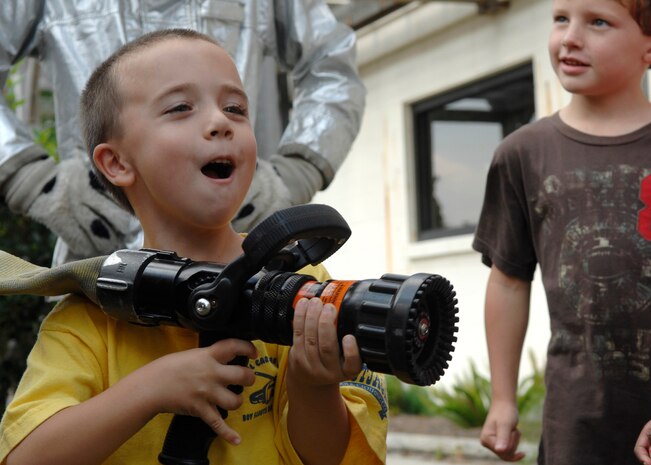 Austin Abel learns how to operate the water hose from a fire truck at Youth Programs on Charleston AFB Oct 7. Firefighers came to Youth Programs to teach children about fire safety during Fire Prevention Week. Austin is the son of Victoria and Staff Sgt. Kurt Abel from the 437th Logistics Readiness Squadron. (U.S. Air Force photo/Airman 1st Class Katie Gieratz)