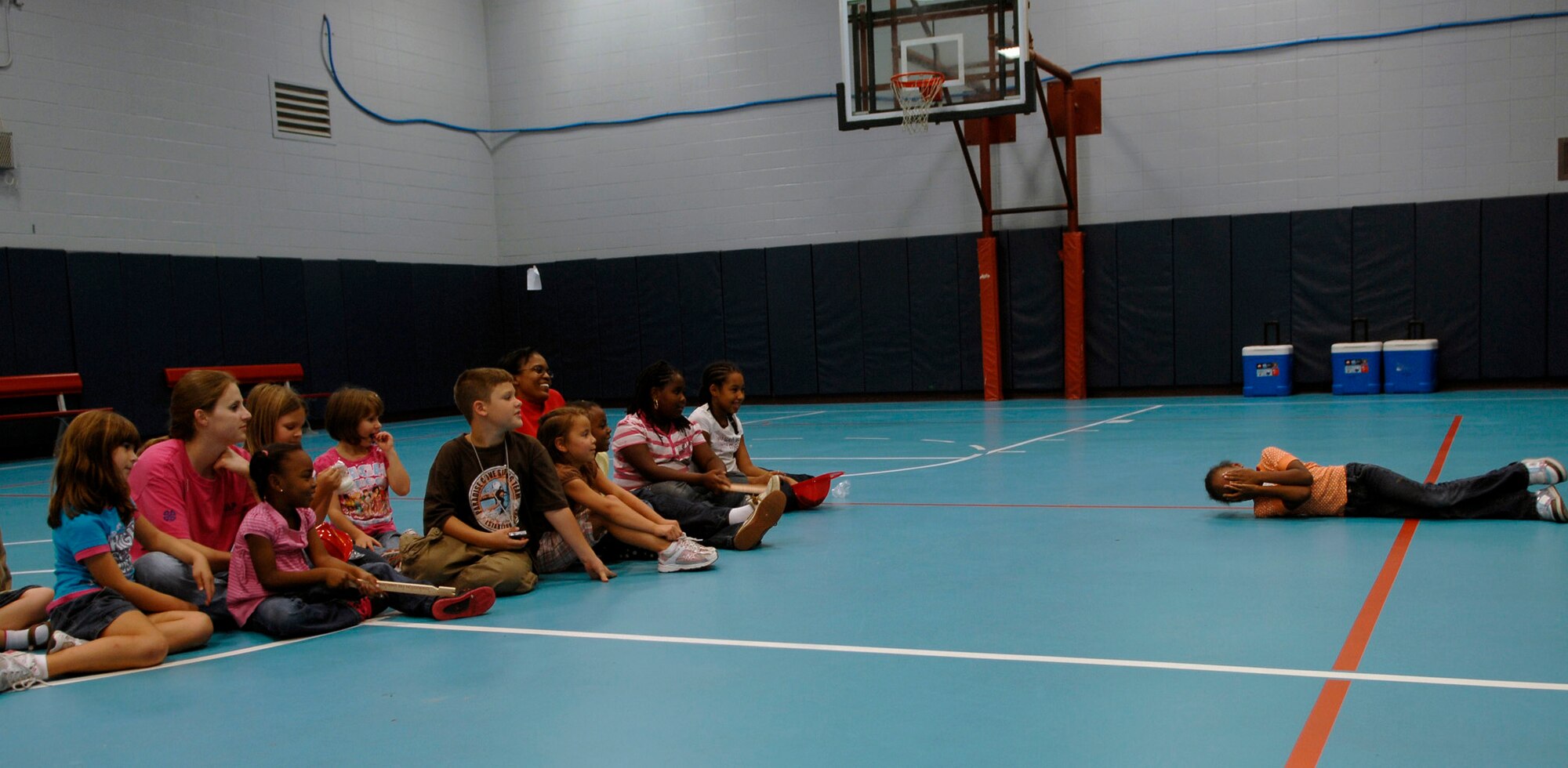 Destiny Brown practices the stop, drop and roll technique in front of other children at the Youth Programs gym on Charleston AFB Oct. 7. Firefighers came to Youth Programs to teach children about fire safety during Fire Prevention Week. Destiny is the daughter of Staff Sgt. Angelique Devor from the 437th Logistics Readiness Squadron and Senior Airman Brett Devor from the 437th Communications Squadron. (U.S. Air Force photo/Airman 1st Class Katie Gieratz)
