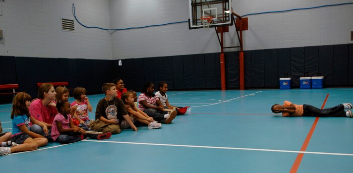 Destiny Brown practices the stop, drop and roll technique in front of other children at the Youth Programs gym on Charleston AFB Oct. 7. Firefighers came to Youth Programs to teach children about fire safety during Fire Prevention Week. Destiny is the daughter of Staff Sgt. Angelique Devor from the 437th Logistics Readiness Squadron and Senior Airman Brett Devor from the 437th Communications Squadron. (U.S. Air Force photo/Airman 1st Class Katie Gieratz)