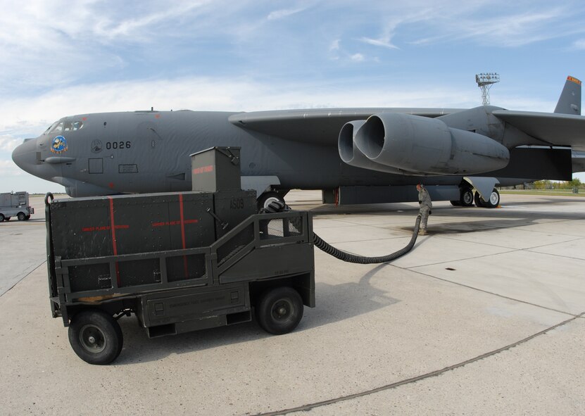 Tech Sgt. Pete Desjardins, 49th Test and Evaluation Squadron, hauls a generator cable up to the engine of the B-52 before going inside the aircraft to ensure the equipment is functioning correctly.  This test requires both the logistical weapons and instrumentation teams to evaluate the equipment.  This is the final inspection the 49th performs before the launch.  Photo by Staff Sgt. Samuel King Jr.