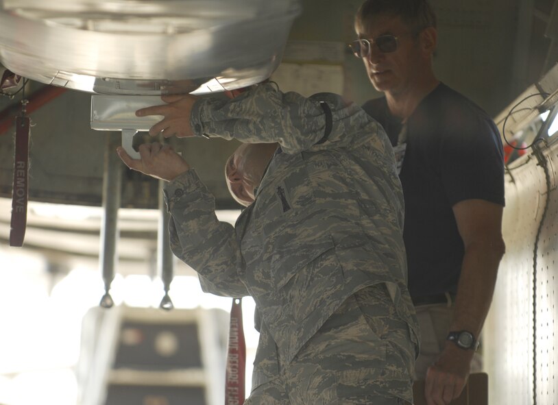 Tech Sgt. Pete Desjardins, 49th Test and Evaluation Squadron, holds up the T-569 machine to verify the weapon is non-nuclear. Willard Hareland from Sandia National Lab, waits to write down the machines read out. The weapon is a 3600 lb. Air-Launched Cruise Missile. It is loaded on a B-52 from the 23rd Bomb Squadron at Minot Air Force Base, N.D. The weapon has already been tested by the 49th TES twice before it ever reaches the aircraft. The entire process is part of the 49th TES’s Nuclear Weapon System Evaluation Program.  Photo by Staff Sgt. Samuel King Jr.
