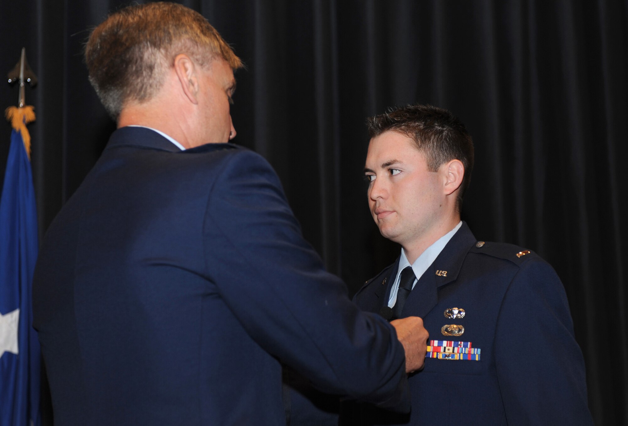 Maj. Gen. Kip Self, U.S. Air Force Expeditionary Center commander, pins the Bronze Star on 1st Lt. Eric Snelgrove, 421st Combat Training Squadron intelligence flight commander, during a ceremony in the Expeditionary Center Sept. 24, 2008.  Lieutenant Snelgrove earned the Bronze Star for a deployment to Iraq in 2007.  (U.S. Air Force Photo/Staff Sgt. Nathan Bevier)