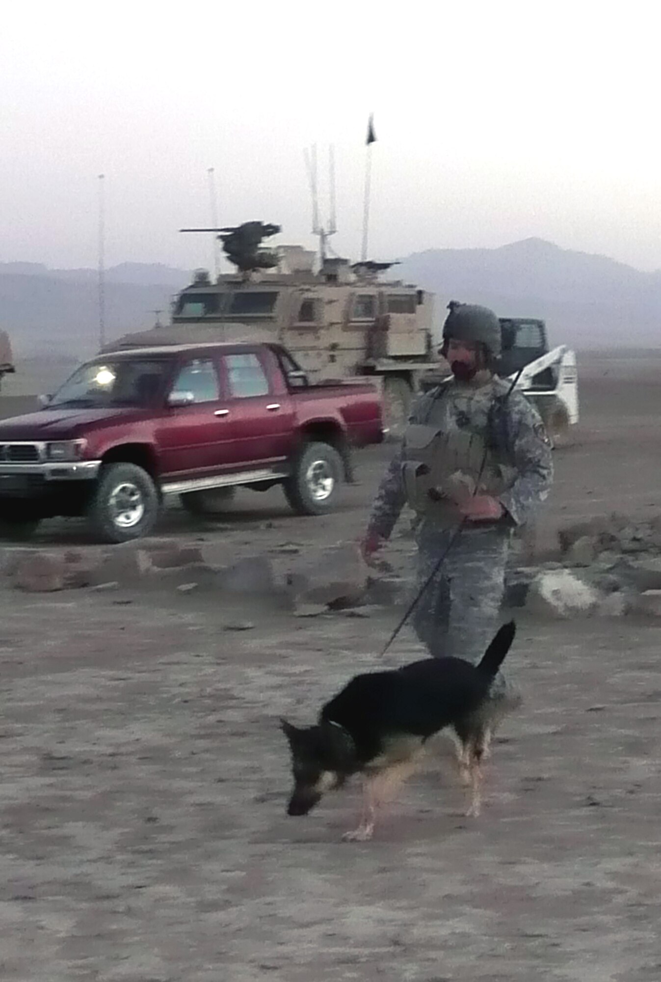 Military working dog Dena, a 6-year-old German Shepherd, and her handler, Staff Sgt. Christopher Dion, perform a sweep while out on a combat mission in Afghanistan Sept. 26, 2008.  The MWD team has been in Afghanistan since May and have been supporting Operation Enduring Freedom.  Before deployment, they both trained in the U.S. Air Force Expeditionary Center's Phoenix Warrior Training Course at Fort Dix, N.J.  Both Sergeant Dion and Dena are deployed from MacDill Air Force Base, Fla.  (U.S. Air Force Photo)