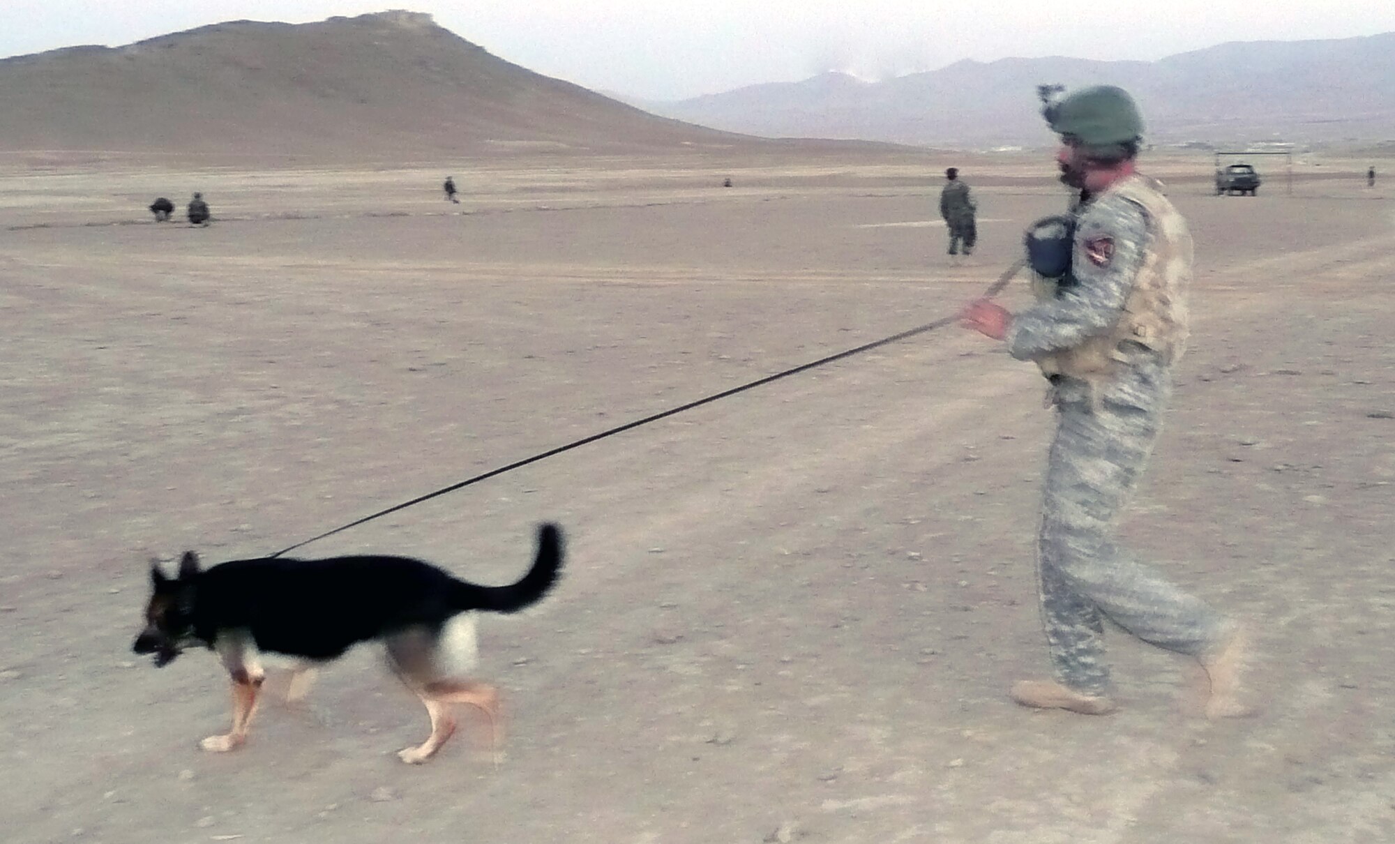 Military working dog Dena, a 6-year-old German Shepherd, and her handler, Staff Sgt. Christopher Dion, perform a sweep while out on a combat mission in Afghanistan Sept. 26, 2008.  The MWD team has been in Afghanistan since May and have been supporting Operation Enduring Freedom.  Before deployment, they both trained in the U.S. Air Force Expeditionary Center's Phoenix Warrior Training Course at Fort Dix, N.J.  Both Sergeant Dion and Dena are deployed from MacDill Air Force Base, Fla.  (U.S. Air Force Photo)