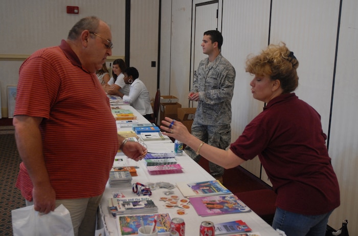 Retired Tech. Sgt. Dan Lali talks to Evelyn Knight at one of the 437th Medical Group displays during the Charleston AFB and Naval Weapons Station Charleston Military Retiree and Spouse Appreciation Day Oct. 4 at the Charleston Club. More than 20 information booths were set up to provide up-to-date information to the retirees and their families on the services offered by Charleston AFB and NWS Charleston. Ms. Knight is with the 437 MDG. (U.S. Air Force photo/Master Sgt. Paul Kilgallon)