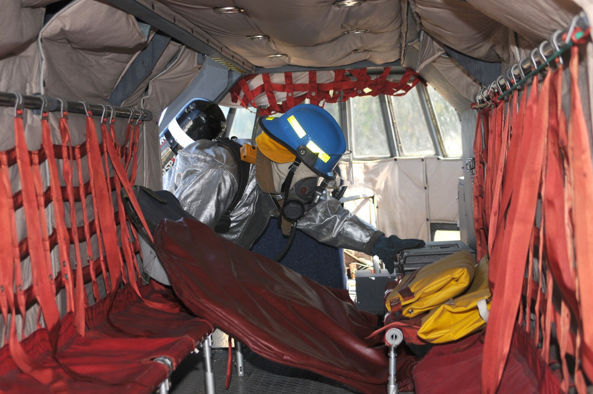 Keesler firefighter David Tijer-ina searches the WC-130J for injured passengers or fatalities.  The scenario for the major accident response exercise involved a crash near a baseball field in Vancleave which killed all 15 people onboard and injured about 20 people on the ground.  (U.S. Air Force photo by Kemberly Groue)
