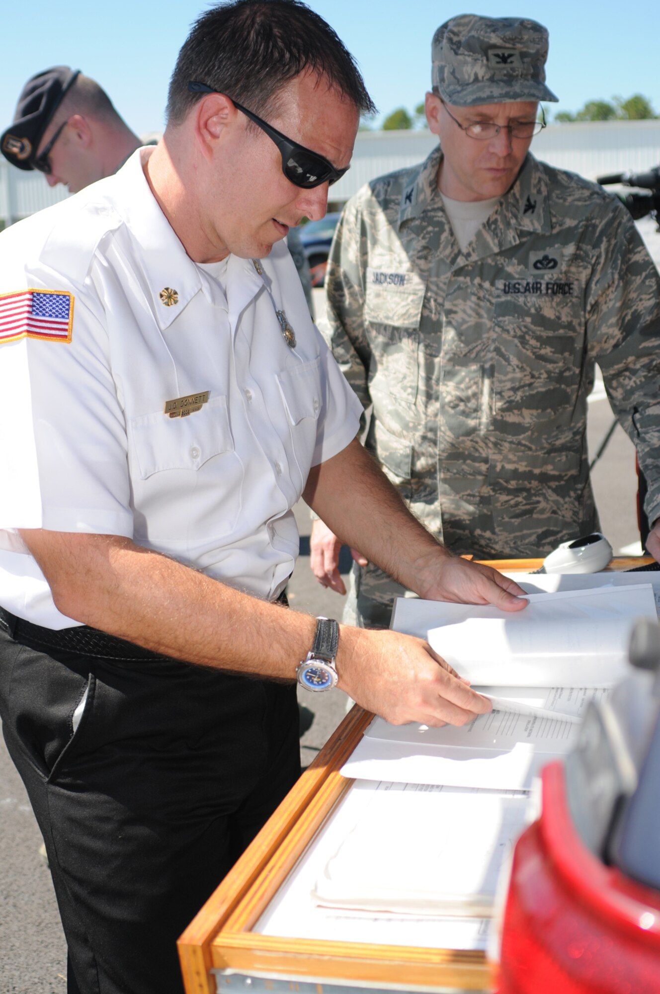 James Donnett, base fire chief, and Col. Jeffrey Jackson, 81st Mission Support Group commander, evaluate the crash site.  The colonel was the onsite commander for the Oct. 1 exercise.  (U.S. Air Force photo by Kemberly Groue)