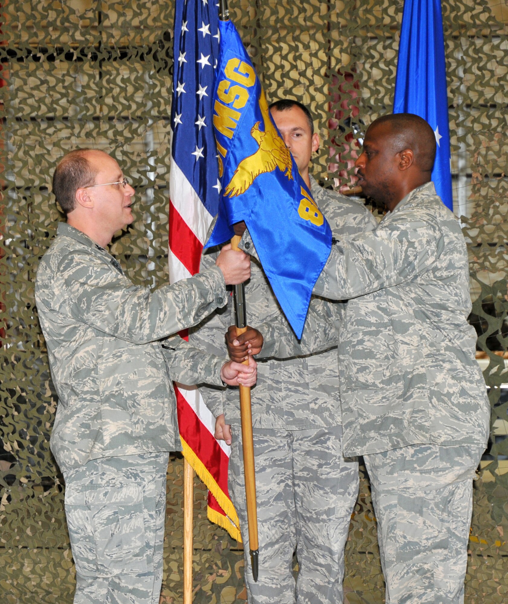 Col. Jeffrey Jackson, left, 81st Mission Support Group commander, passes the guidon to Maj. Clarence Lee, 81st Logis-tics Readiness Squadron commander, Oct. 1 during the squadron’s activation ceremony.  The former 81st Supply and Transpor-tation Squadrons have merged to form the new squadron.  Keesler is the last base in the Air Force to make the transition, be-cause of the A-76 study which turns over many base support services to a contractor, as well as the devastation caused by Hurricane Katrina three years ago.  (U.S. Air Force photo by Adam Bond)