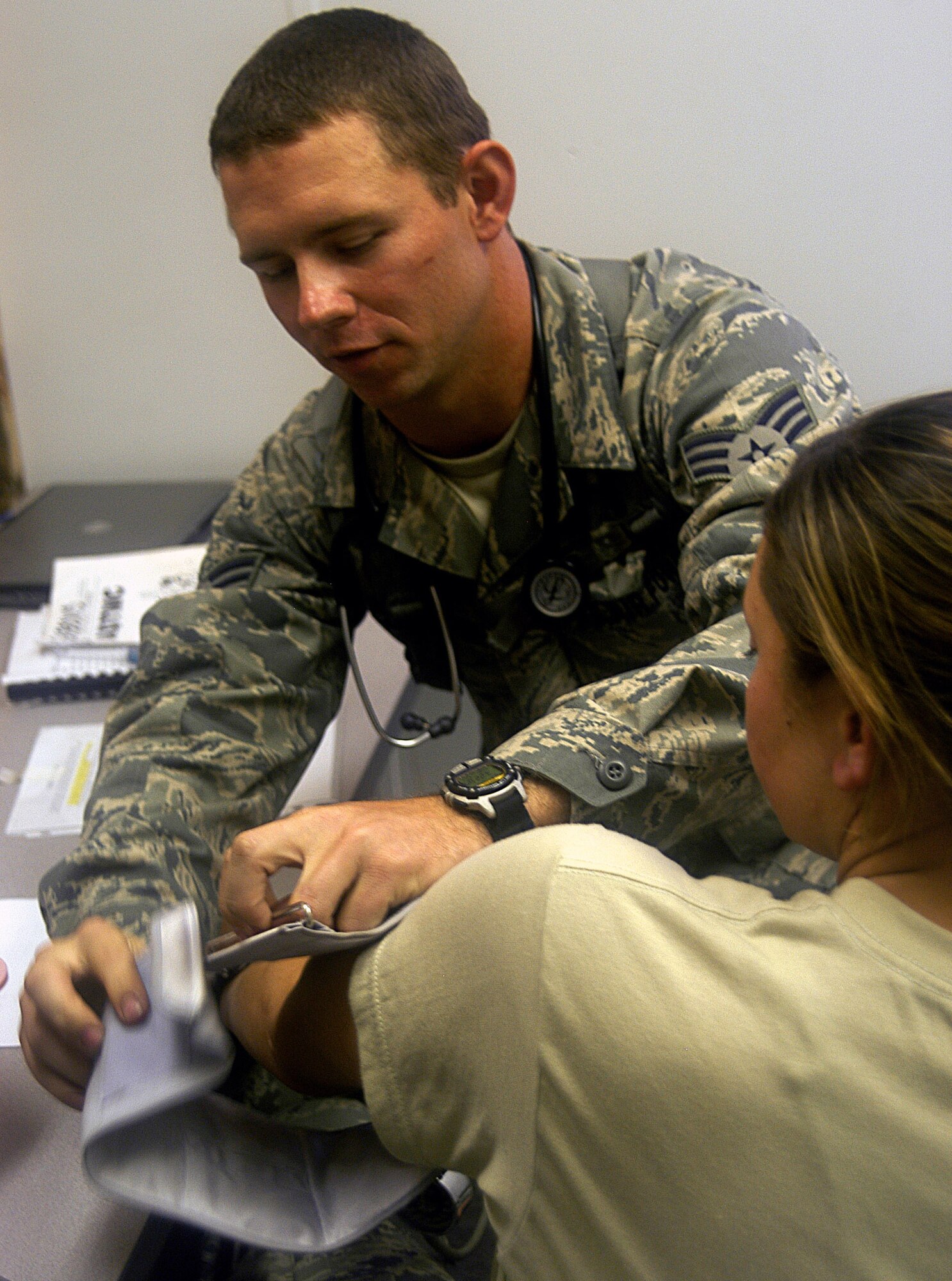 Airman Williams applies a blood pressure cuff to a patient at a “forward deployed” clinic Sept. 23 at Fort Bragg. Airman Williams is in combat skills training for an upcoming deployment to Afghanistan.  (U.S. Air Force photo by Master Sgt. Eric Grill)
