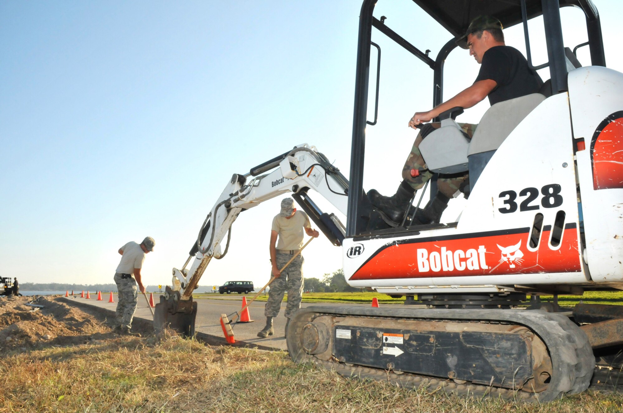 From left, Staff Sgt. Russell Wrenn, Airman 1st Class Joseph Roach and Staff Sgt. Blake Roberts, 81st Civil Engineer Squadron, work to remove the parking lot adjoining a pier north of the flight line on Biloxi’s Back Bay.  By removing the parking lot from the runway’s “clear zone,” Keesler is removing a potential hazard for aircraft accidents and promoting a safety-first attitude for flying operations, according to 1st Lt. Laura Chighizola, 81st Operations Support Flight.  (U.S. Air Force photo by Adam Bond)