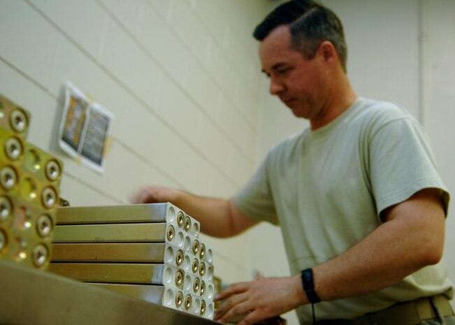 Tech. Sgt. Jerry Hairr removes expired C-17 flares from a MJU-34/A flare magazine on Charleston AFB Oct. 6. The flares? shelf life is 12 months, sothey are removed annually and shipped to Crane Army Ammunitions Center in Indiana for disposal. Sergeant Hairr is a munitions systems craftsman assigned to 437th Maintenance Squadron. (U.S. Air Force photo/Airman 1st Class Katie Gieratz)