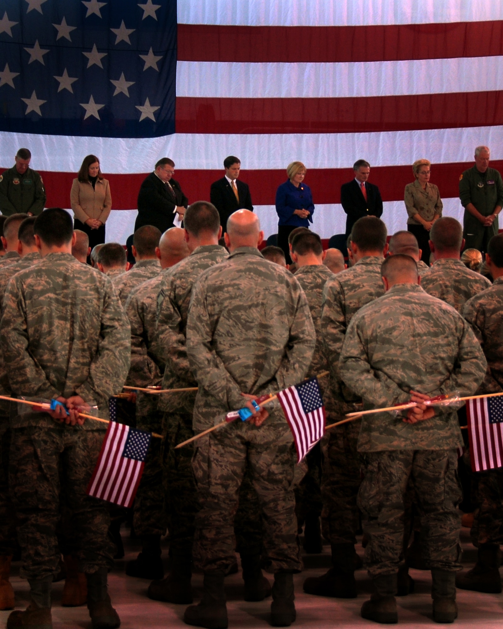 Members of the 180th Fighter Wing and distinguished guests bow their heads in prayer at the send-off ceremony October 5, 2008 to honor our servicemembers for thier upcoming deployment in support of Operation Enduring Freedom and Operation Iraqi Freedom. Photo by Airman First Class Amber Williams