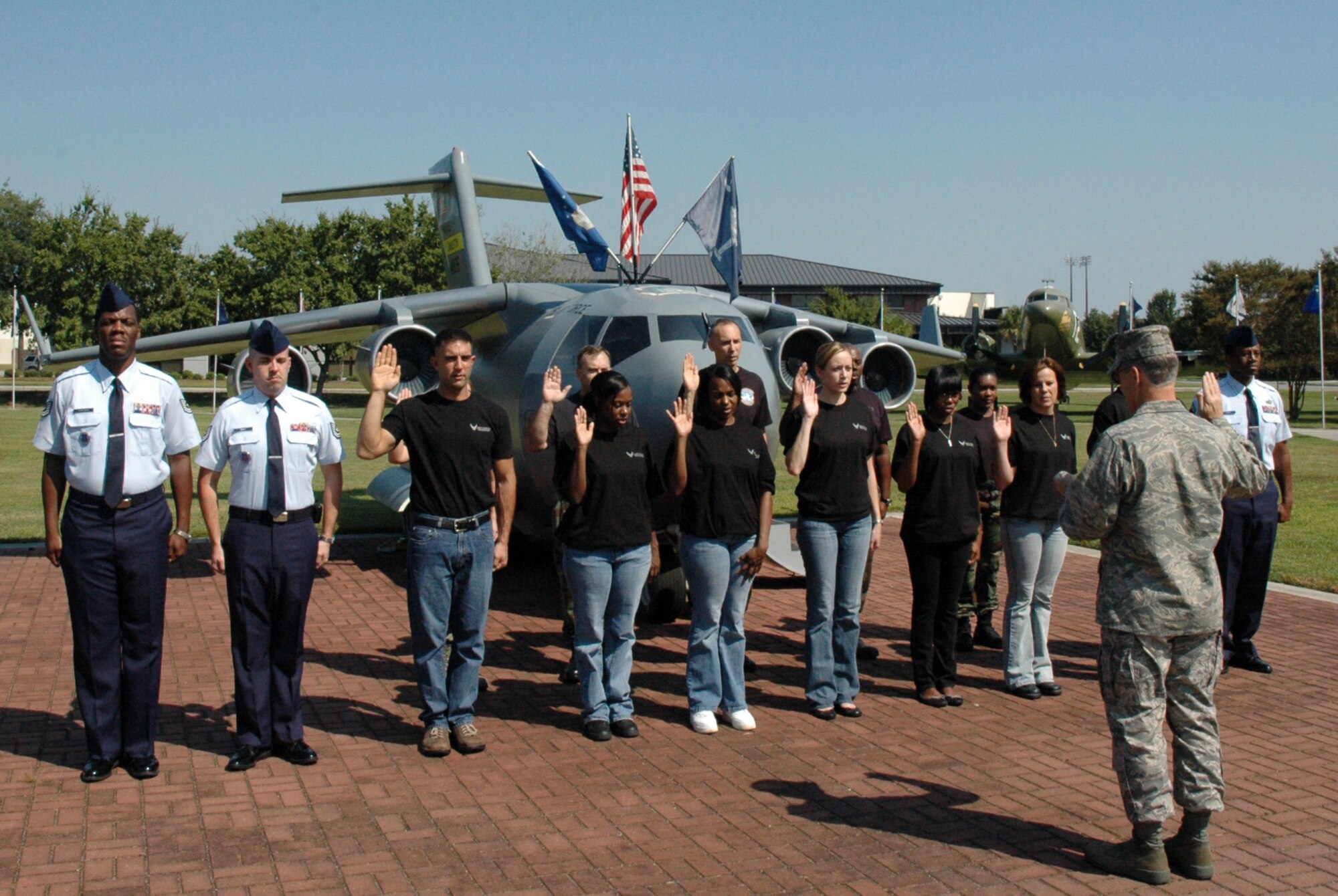 315th Airlift Wing Commander Colonel Timothy Wrighton administers the Oath of Enlistment during a mass enlistment ceremony held in front of the wing's Mini C-17 replica on October 4, 2008.  Some members of the group enlisted for the first time, while others re-enlisted.  315th AW recruiters consistantly find the highest quality recruits to fill positions within the wing. (U.S. Air Force photo/Capt. Wayne Capps)