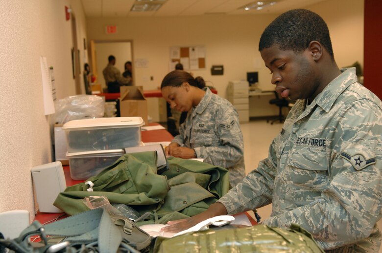 Airman Brandon Smith, 755th Operations Support Squadron aircrew flight equipment technician, organizes mobility equipment here, September 25. (U.S. Air Force photo/Senior Airman Noah R. Johnson)
