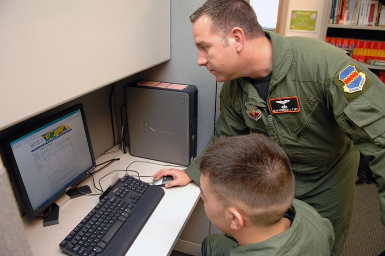 Technical Sgt. Sean Dougherty, 755th Operations Support Squadron command language program manager, reviews authentic language material with Airman 1st Class Charles Robert, 43rd Electronic Combat Squadron cryptologic linguist, here, September 25. (U.S. Air Force photo/Senior Airman Noah R. Johnson)
