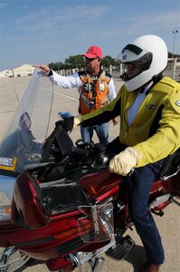 Ronald Dalton (background left), 12th Flying Training Wing volunteer motorcycle safety course instructor, gives last-minute instructions to a student about to demonstrate a maneuver during last month's motorcycle safety course. (U.S. Air Force photo by Dave Terry.)  