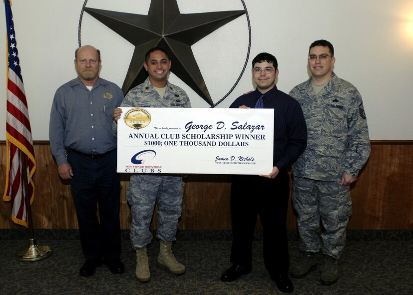 DYESS AIR FORCE BASE, Texas -- George Salazar, 19, a sophomore at Cisco Jr. College, is awarded a $1,000 Air Force scholarship Oct. 7 by Maj. Nolan Corpuz, 7th Force Support Squadron commander. Only twenty-five individuals were selected to receive the scholarship through the Air Force Club Membership Scholarship Program this year. Club members and their families were given the opportunity to submit a 500-word essay on “The most important person in my life.” Essays were chosen by each participating base. George is the son of Master Sgt. George Salazar, a 317th Aircraft Maintenance Squadron C-130 maintainer. Young George plans to use the money to buy books for the five classes he is taking this semester. He holds a 3.5 grade point average.  Sergeant Saldazar said this award proves that “being a club member pays!” For more information on joining the Club, and for a chance to participate in next year's essay contest, contact Jim Nichols, Dyess' Club manager. (U.S. Air Force photo/Airman 1st Class Stephen Reyes)