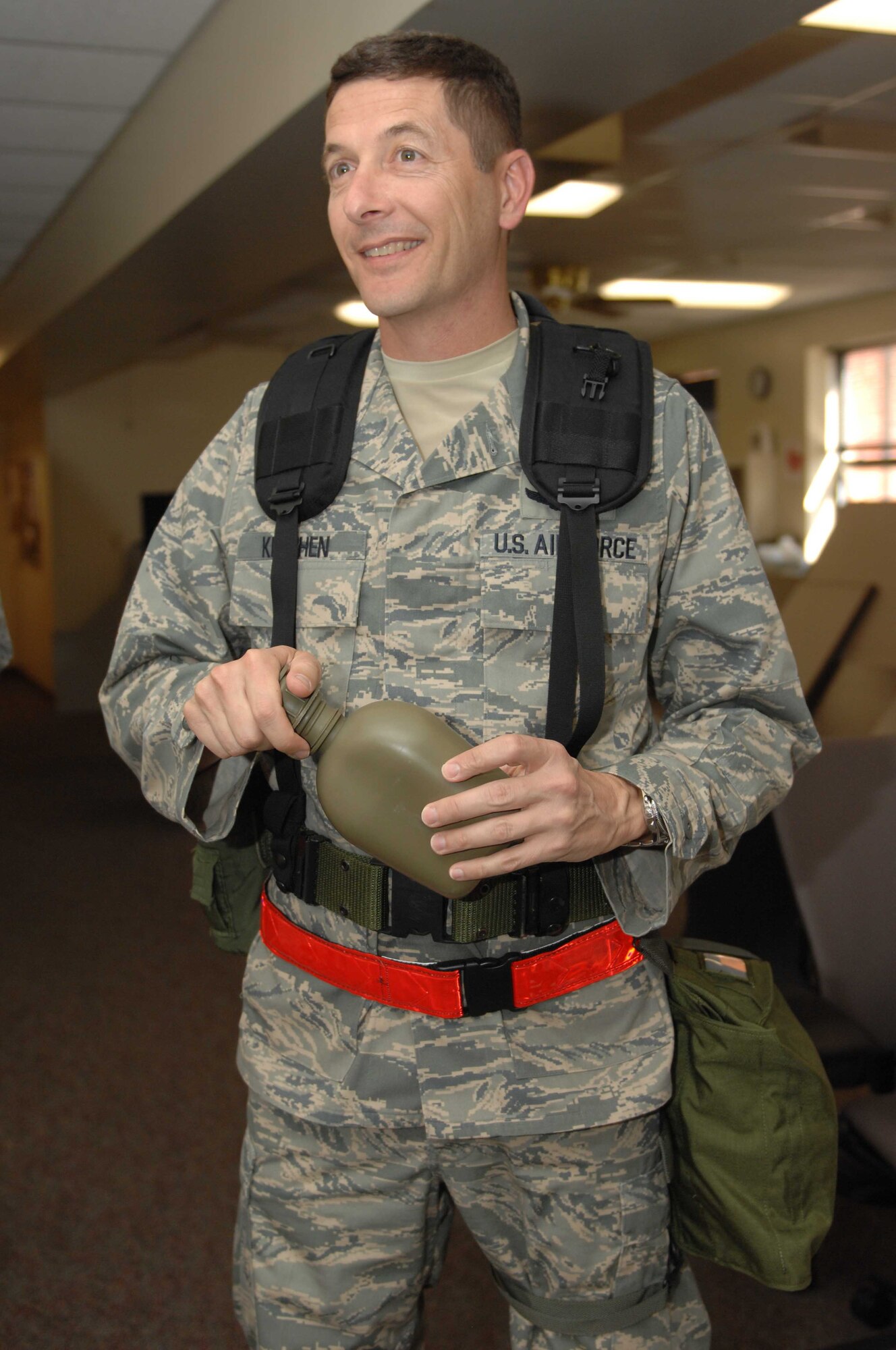 DYESS AIR FORCE BASE, Texas — Colonel Gavin Ketchen, 7th Bomb Wing Vice Commander, reminds everyone to keep their canteens full with water before they process through the deployment line Oct. 5. (U.S. Air Force photo/ Senior Airman Domonique Simmons)