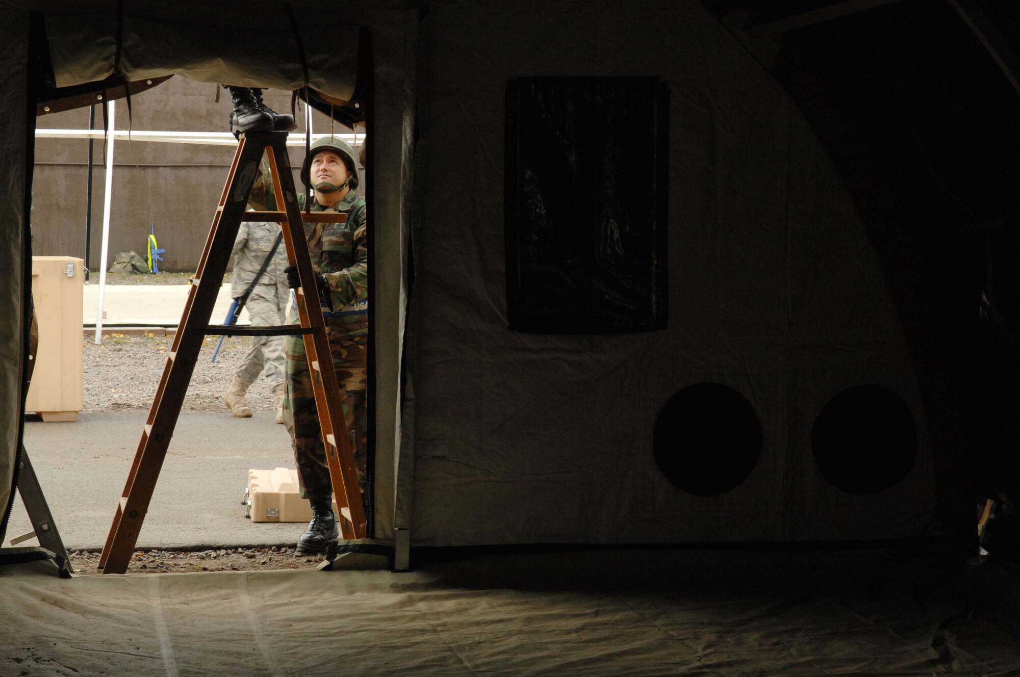 United States Air Force Staff Sgt. Keith Manibusan, 65th Civil Engineer Squadron, Lajes Field, Azores, assists with building a bare-base in support of the Silver Flag exercise 09-01, Ramstein Air Base, Germany, Oct. 7, 2008. Silver Flag provides expeditionary combat support training to Airmen in the civil engineer, personnel services, contracting and services career fields, preparing them for upcoming deployments. (U.S. Air Force photo by Senior Airman Amber Bressler)(Released)*
