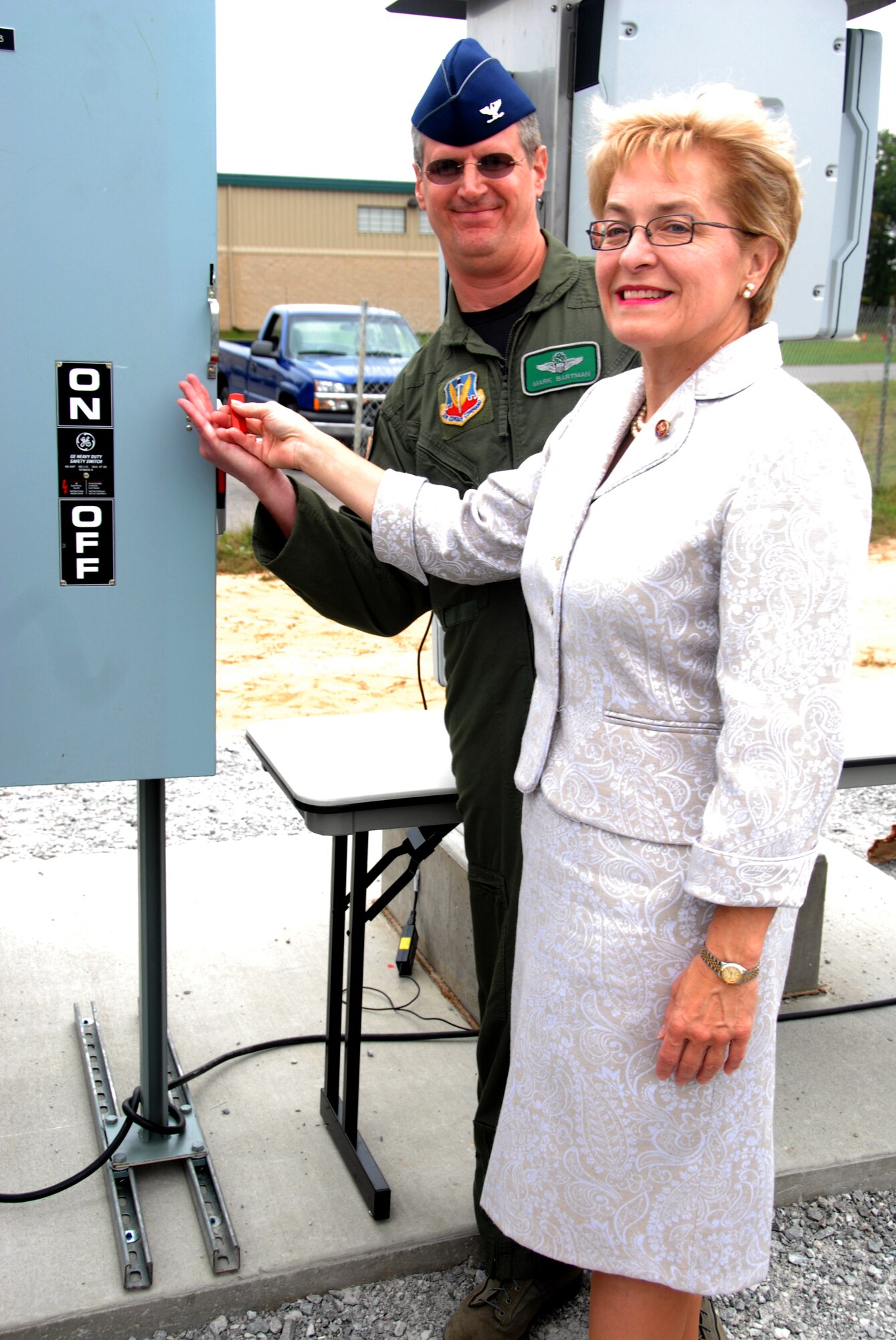 Col. Mark E. Bartman, 180th Fighter Wing Commander, Ohio Air national Guard and Congresswoman Marcy Kaptur turn on the power at the 180th Fighter Wing's Alternative Energy site on September 27, 2008. The solar field is part of the 180th FW's Renewable Energy Project, funded by the Department of Defense Research and Development Program in an effort to reduce the 180th's use of limited fossil fuel and dependence on foreign energy sources. Once completed, the solar field is expected to produce 800-900 Kilowatts of electricity, which will allow the 180th to save approximately 37.5% on the annual electricity budget. The solar field will also reduce the amount of coal burned to produce energy by almost 250 tons annually, while at the same time reducing harmful emissions and greenhouse gasses. USAF Photo by Senior Airman Jodi Joice (Released).