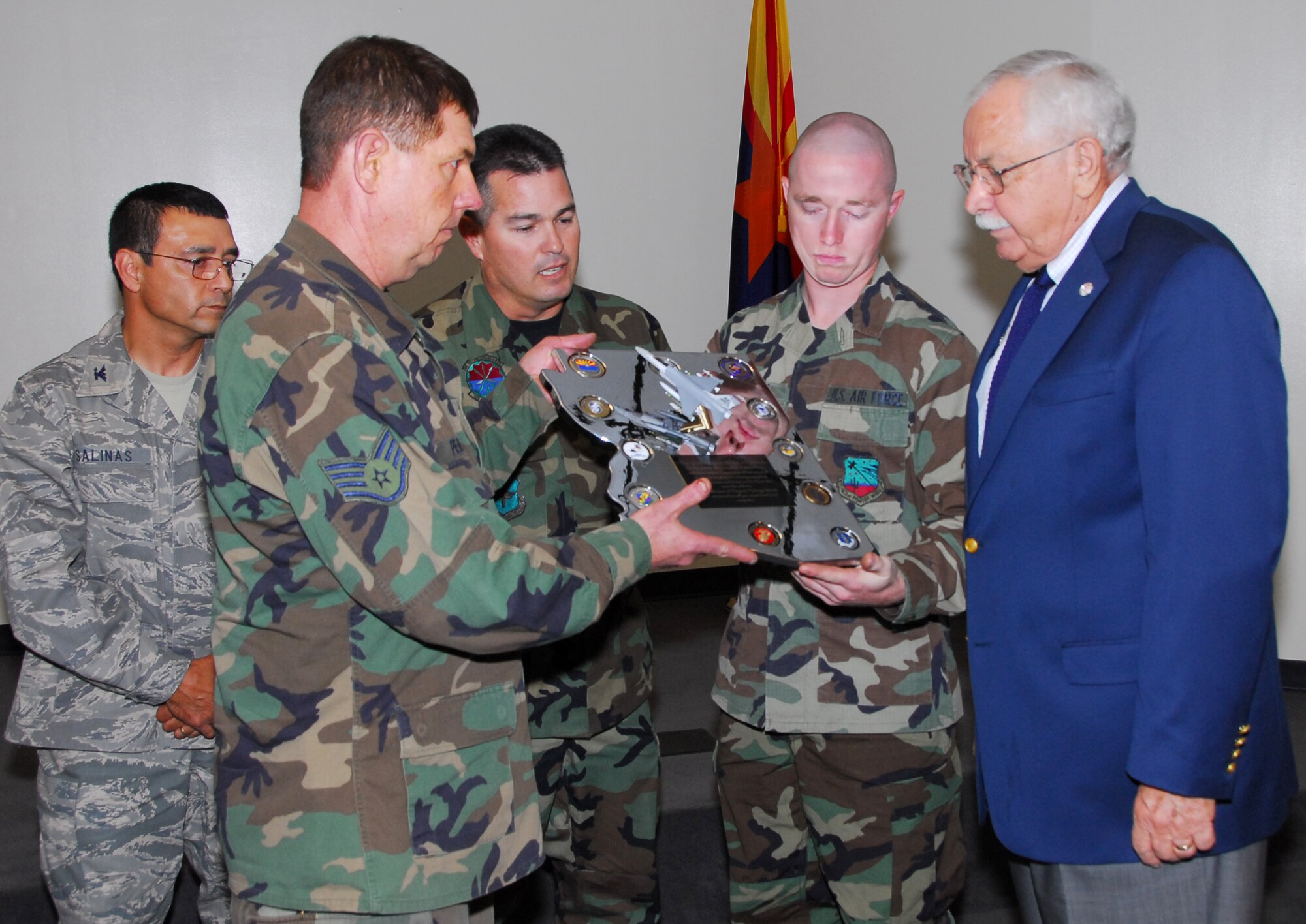 (From left to right) Col. Jose Salinas, vice wing commander, looks on while Staff Sgt. Robert Pensas, Master Sgt. Miguel Islas, and Senior Airman Ben Koughn present Mr. William Valenzuela a chromed plaque they constructed by hand. The plaque reads, “The 162nd recognizes Mr. William Valenzuela for his outstanding support of the military and their families. Your tireless efforts on behalf of our unit are a shining example of your patriotism and deep love for those who wear the uniform. In celebration of Hispanic Heritage Month we are proud to call you a true friend and compadre.” (Air National Guard photo by Master Sgt. Dave Neve)