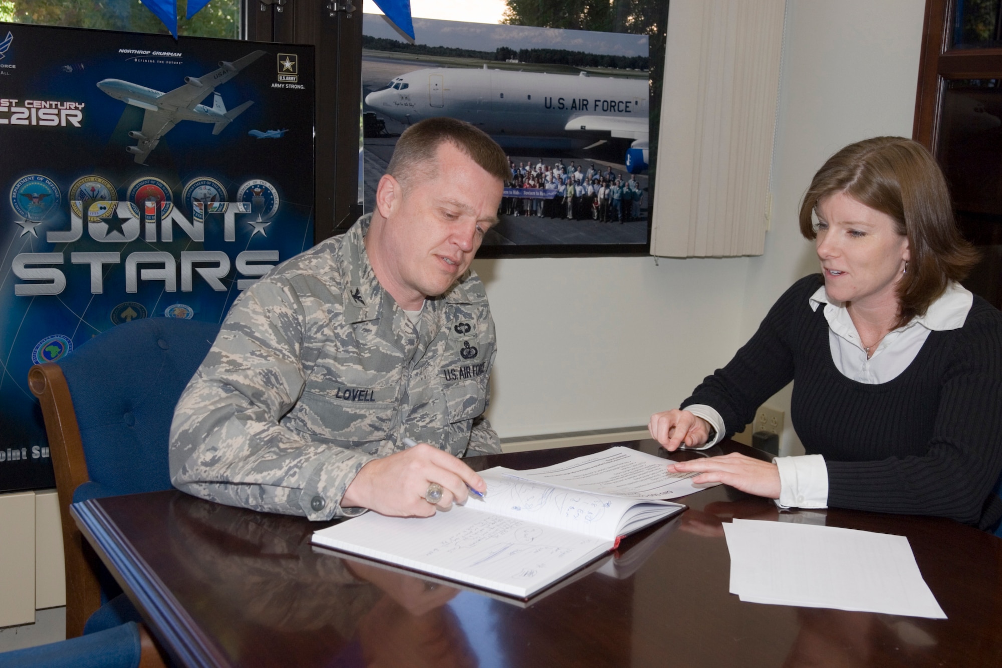 Col. Jim Lovell, 751st Electronic Systems Group commander, prepares a briefing with Melissa Davison, 751 ELSG Commander's Execution Group. Prior to commanding the 751 ELSG, Colonel Lovell worked as director of the Defense Transportation Coordination Initiative at United States Transportation Command. (U.S. Air Force photo by Rick Berry)