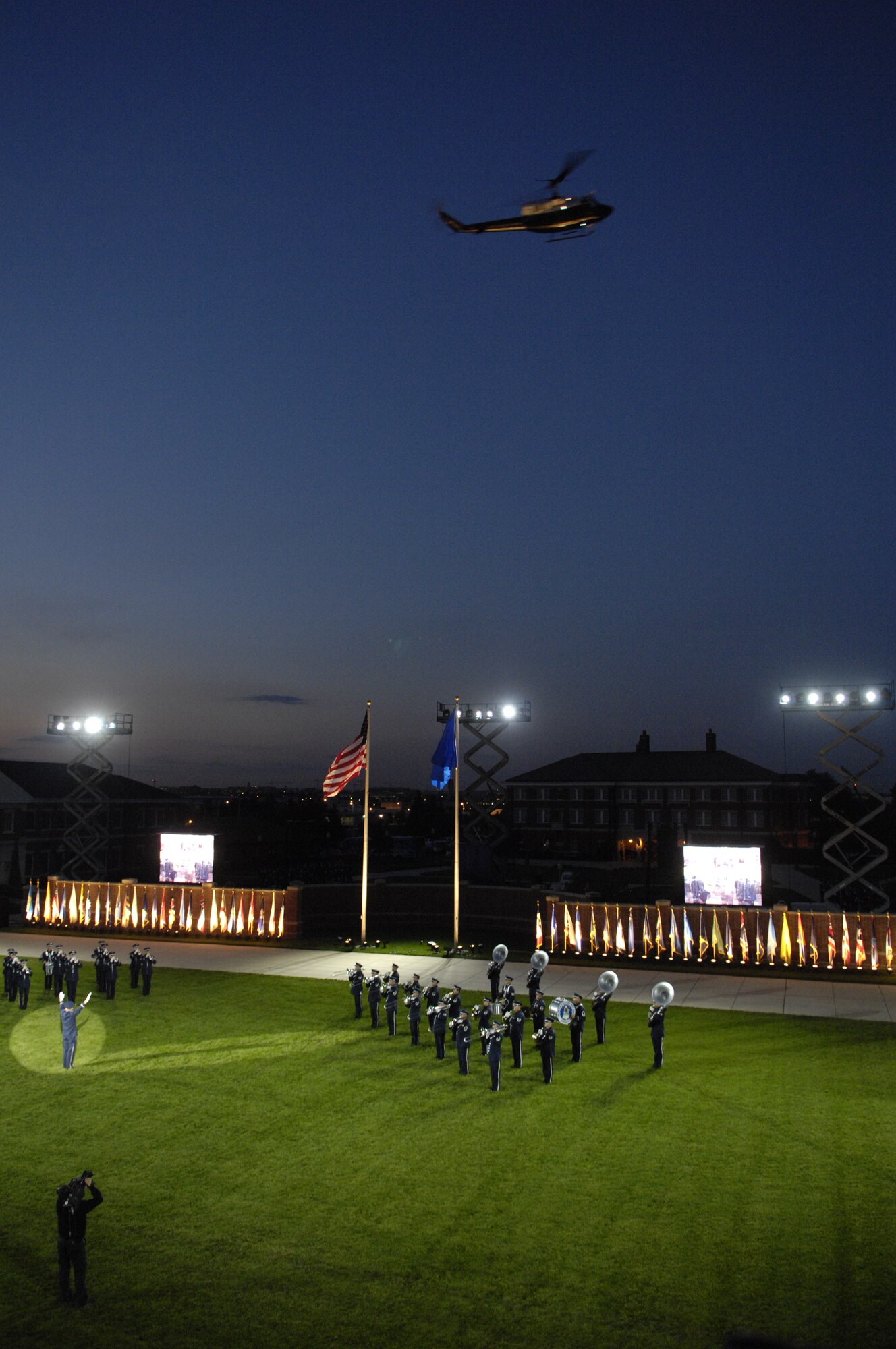Members of the U.S. Air Force Band play as a helicopter from the 1st Helicopter Squadron, Andrews Air Force Base, Md., flies over during the Tattoo on Bolling Oct. 6. The Tattoo, themed "Securing Our Freedom," was held in conjunction with the 2008 NATO Air Chiefs' Conference, hosted by Gen. Norton A. Schwartz, Air Force chief of staff.  (U.S. Air Force photo by Airman 1st Class Sean Adams) (Released)
