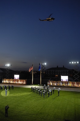 Members of the U.S. Air Force Band play as a helicopter from the 1st Helicopter Squadron, Andrews Air Force Base, Md., flies over during the Tattoo on Bolling Oct. 6. The Tattoo, themed "Securing Our Freedom," was held in conjunction with the 2008 NATO Air Chiefs Conference, hosted by Gen. Norton A. Schwartz, Air Force chief of staff. (U.S. Air Force photo by Airman 1st Class Sean Adams) (Released) 
