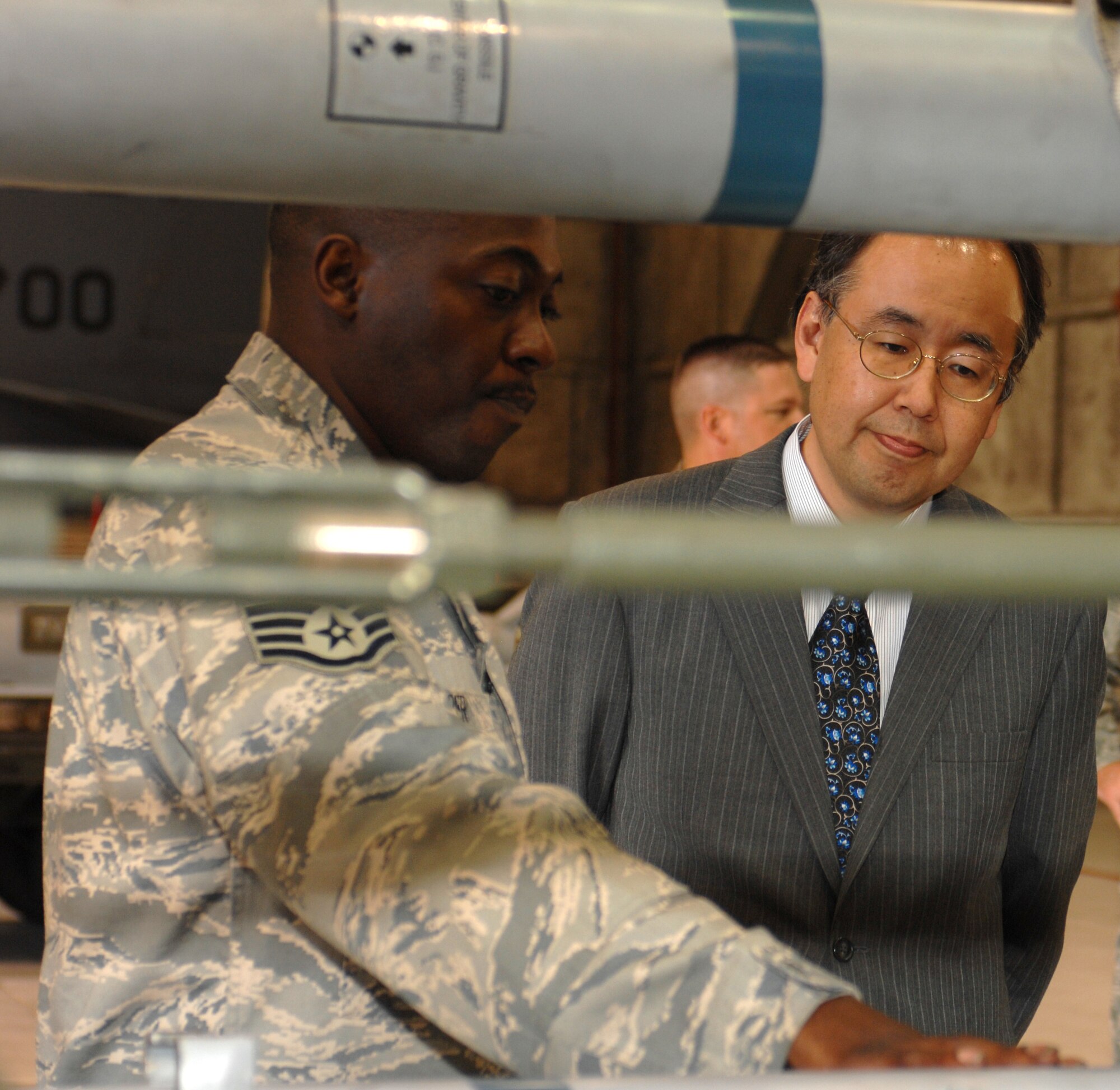 Staff Sgt. Mario Harper from the 4th Maintenance Operations Squadron explains how the AIM 9LM missile operates to Hiroshi Sasaki, October 7, 2008 on Seymour Johnson Air Force Base, North Carolina. Hiroshi Sasaki is the executive director of Japan's Local Government Center. (U.S. Air Force photo by Airman 1st Class Gino Reyes)