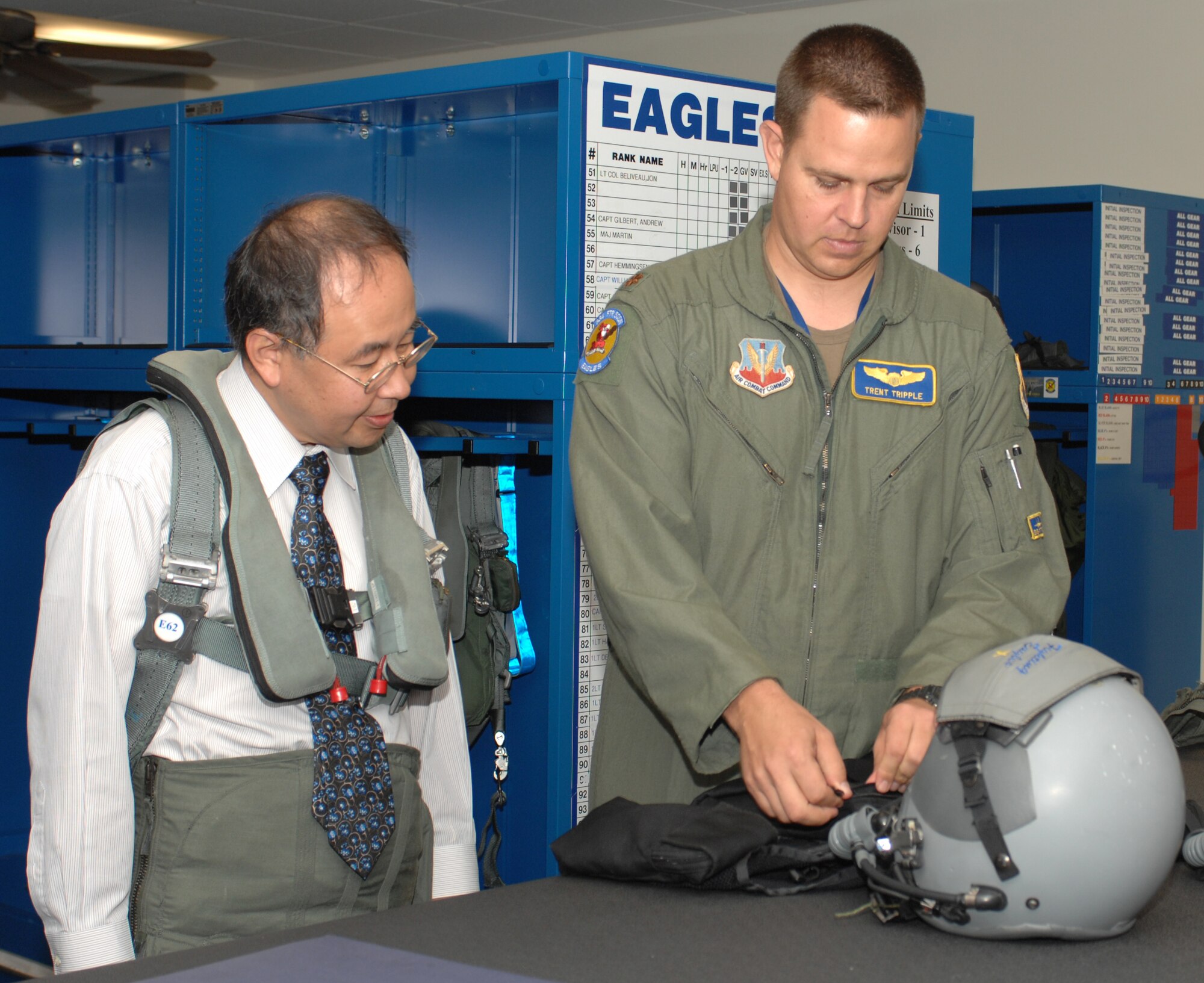 Major Trent Tripple of the 334th fighter squadron explains how to properly wear the CSU 13 B/P flightsuit to Hiroshi Sasaki October 7, 2008 on Seymour Johnson Air Force Base, North Carolina. Hiroshi Sasaki is the executive director of Japan's Local Government Center. (U.S. Air Force photo by Airman 1st Class Gino Reyes)