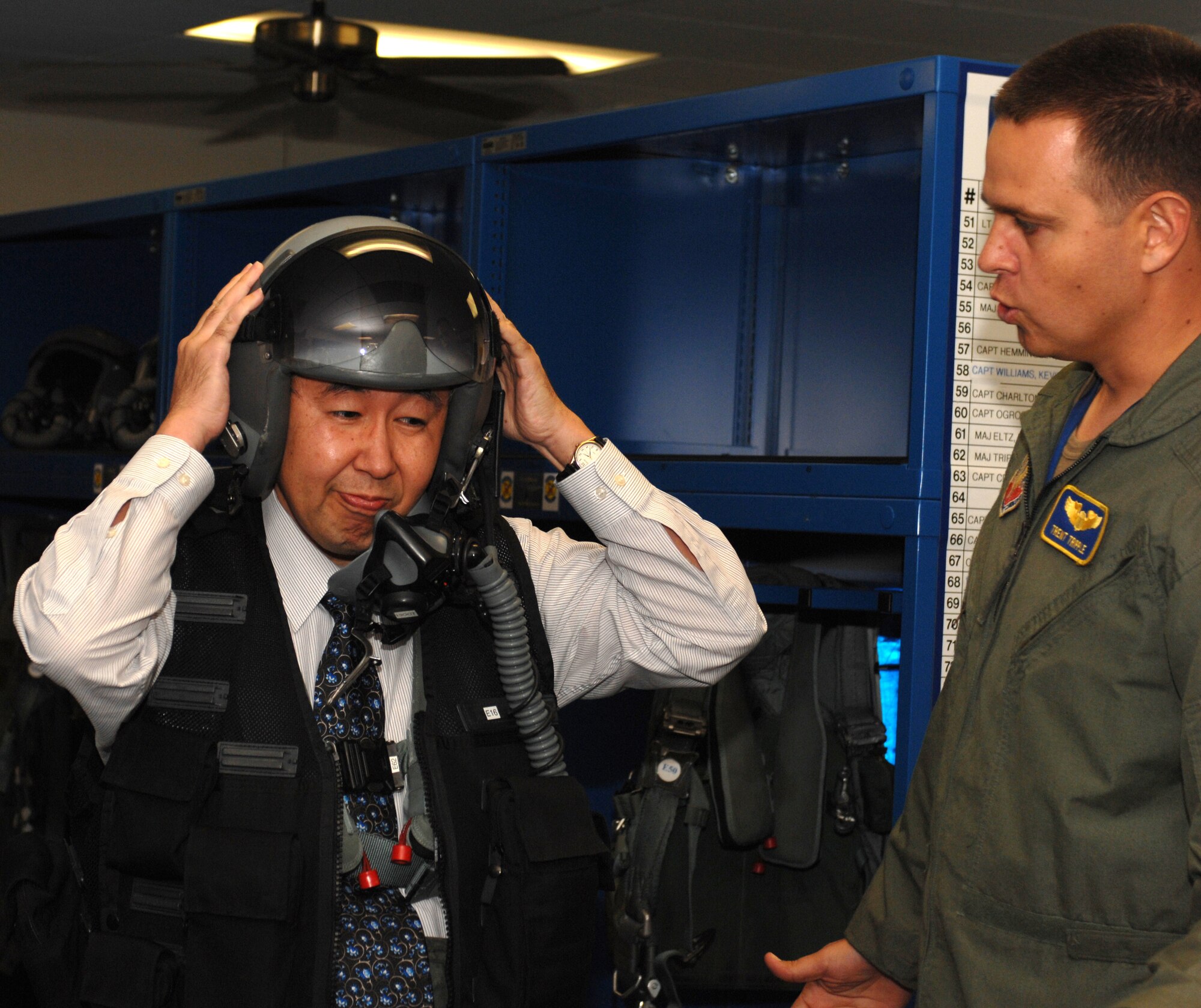 Major Trent Tripple of the 334th fighter squadron explains the purposes of the CSU 13 B/P flight suit to Hiroshi Sasaki October 7, 2008 on Seymour Johnson Air Force Base, North Carolina. Hiroshi Sasaki is the executive director of Japan's Local Government Center. (U.S. Air Force photo by Airman 1st Class Gino Reyes)