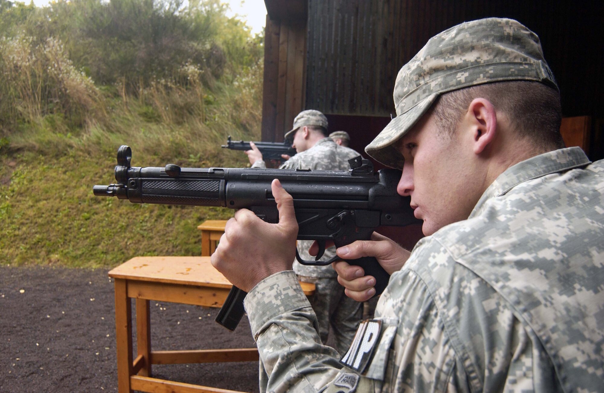 The U.S. Army Garrison Kaiserslautern's team checks out their line of site before being handed their safety gear in the rifle contest Oct. 1 at the international shooting competition hosted by the German Police Academy in Enkenbach-Alsenborn. Team members are (left) Sgt. Martin Harless, Spec. David Stewart and Sgt. Jared Wescoat. (Photo by Christine June, USAG Kaiserslautern)             
