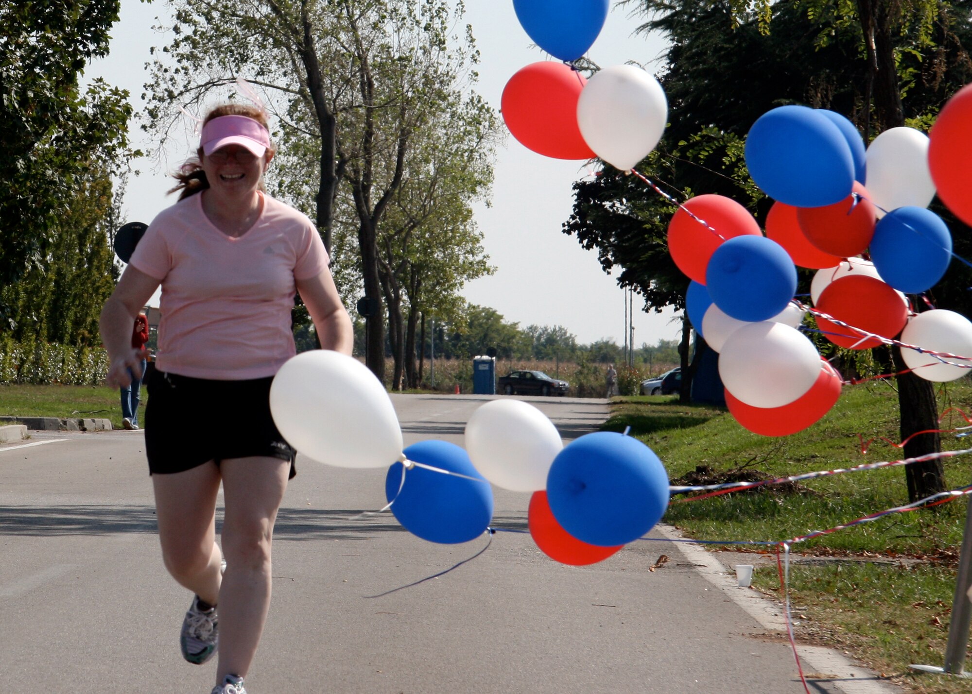 Tech. Sgt. Angel Rios, 100th FForce Support Squadron Fitness Center, crosses the finish line at the Aviano Air Base Marathon in Italy to complete her very first marathon. (U.S. Air Force photo)