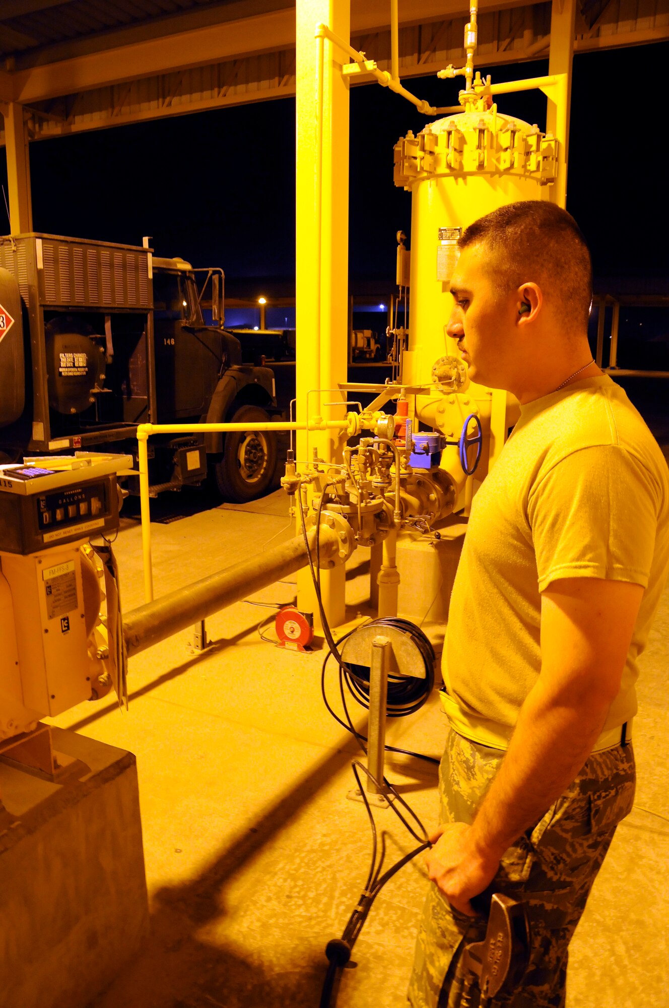 Airman 1st Class David McNabb, 379th Expeditionary Logistics Readiness Squadron, watches the numbers zip around as the gallons rush into his fuel truck October 7, 2008.  Even though he doesn't have to pay for this tank full, he still must keep track and account for every gallon he pumps.  Working the night shift is non-stop as Airman McNabb fills his truck for the first of many fill-ups tonight at an undisclosed air base in Southwest Asia.  The fuel truck drivers do their jobs night and day, keeping the jets fueled and ready to fly whenever the mission calls for them.  Airman McNabb, a native of Ontario, Calif., is deployed from Dover Air Force Base, Del., in support of Operations Iraqi and Enduring Freedom and Joint Task Force-Horn of Africa.  (U.S. Air Force photo by Tech. Sgt. Michael Boquette/Released)